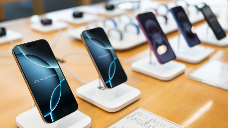 A row of iPhone 16 models on display at a retail outlet.