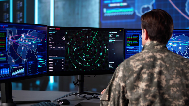 A modern radar system being monitored by military personnel