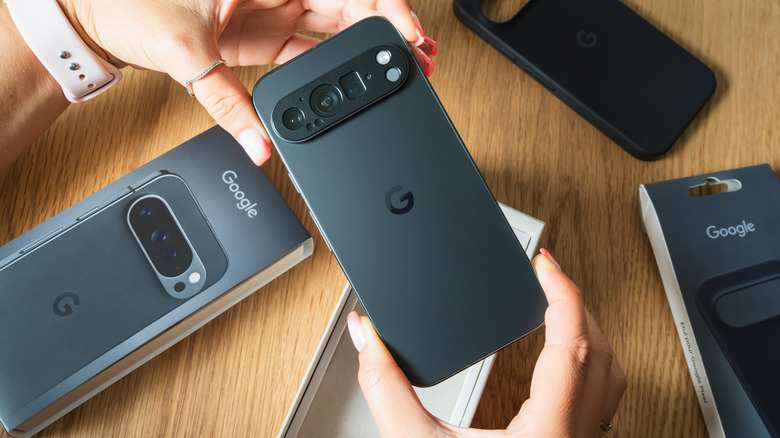 A pair of woman's hands holding a Google Pixel device seemingly as it was unboxed