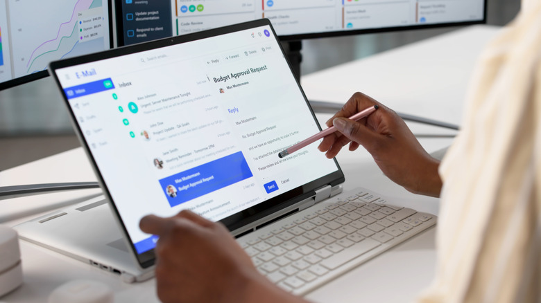 Close up of someone checking a generic email inbox on a laptop