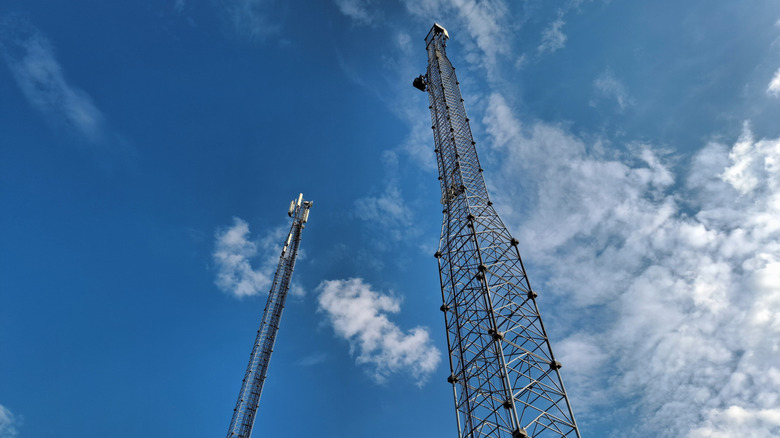 Cell towers against a cloudy sky.