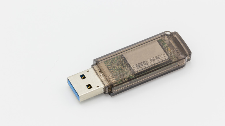 A USB stick sitting on a white background.