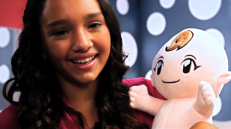 Babysitting Mama Trailer screenshot of child holding doll