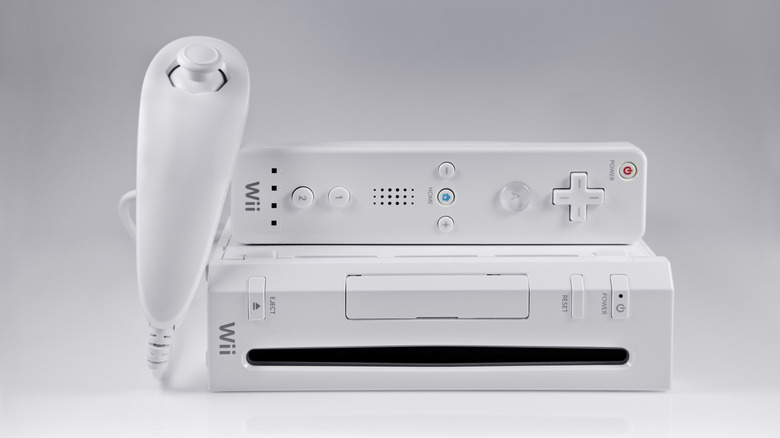 Wii on its side with controller and nunchuck