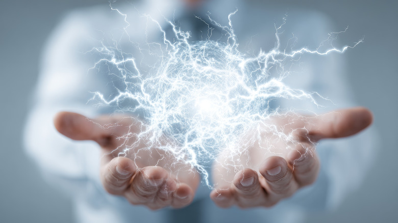 man holding electricity in his hands