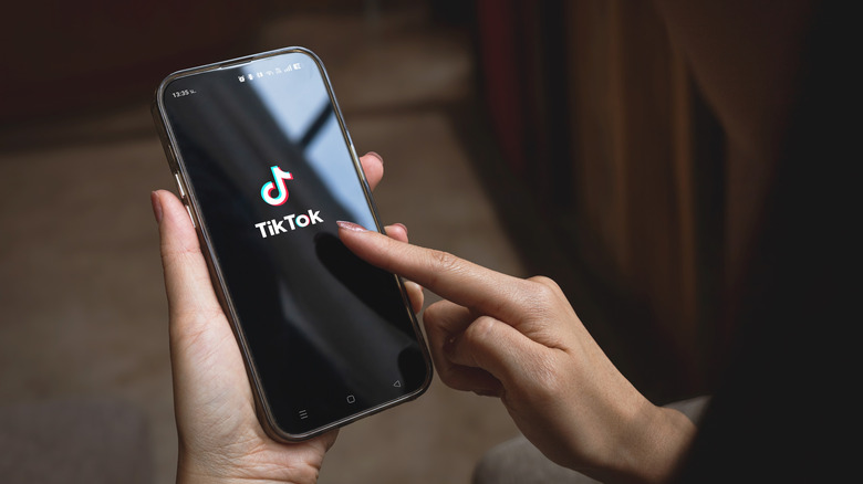 A woman using the TikTok app on an Android phone.