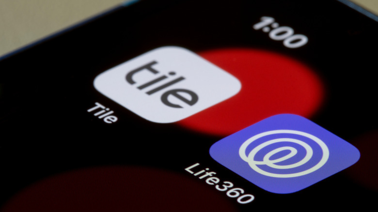 Life360 and Tile app logos next to each other on smartphone