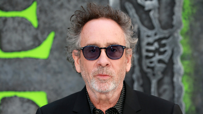Writer/Director Tim Burton at a red carpet event for Beetlejuice Beetlejuice wearing dark glasses
