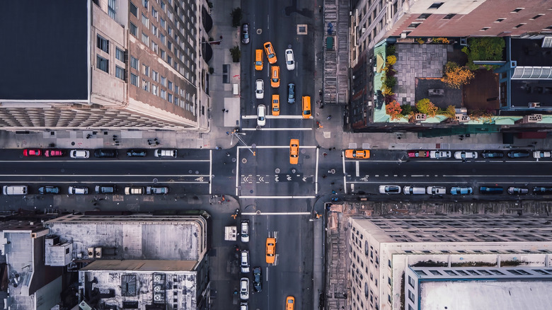 an overhead view of cars at a busy intersection in a city