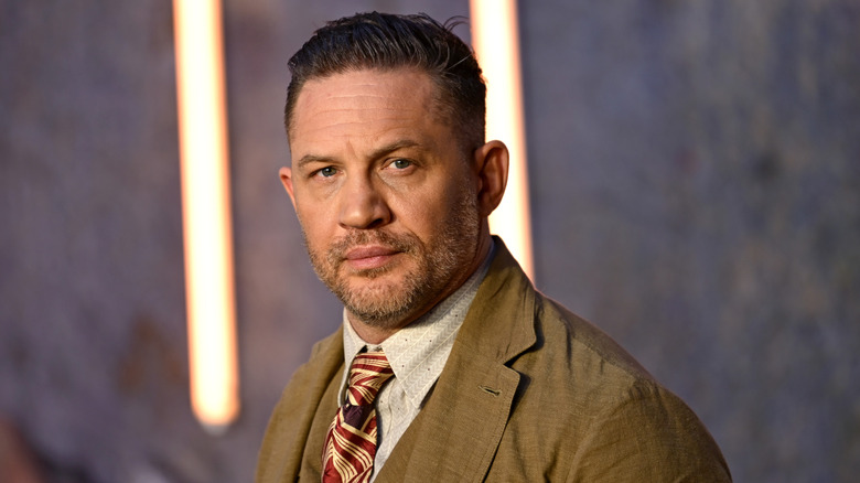 Tom Hardy looking toward the camera while at an event