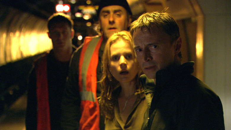 The cast of Flood, with Tom Hardy in the background