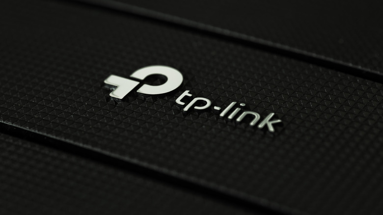 TP-Link logo on a modern, high-tech background.