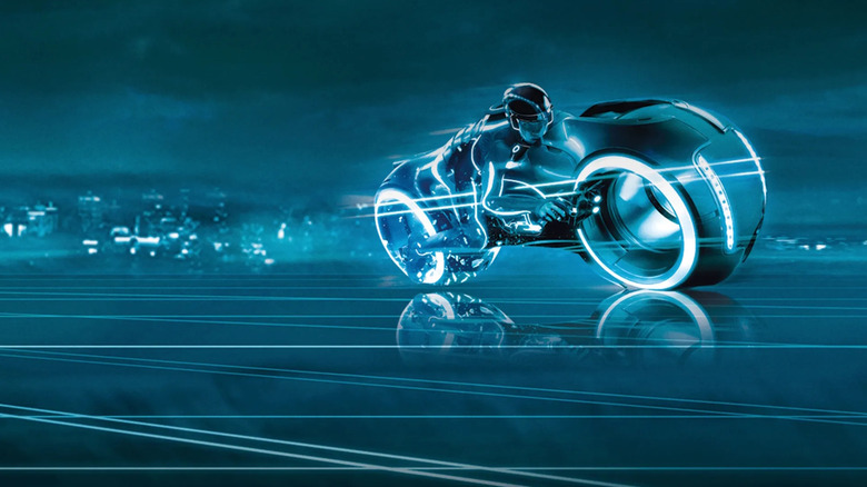 Tron Legacy key art of bike driving across blue computer landscape