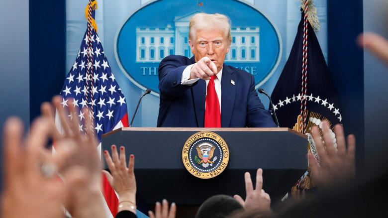 President Trump in Whitehouse press office, pointing at camera
