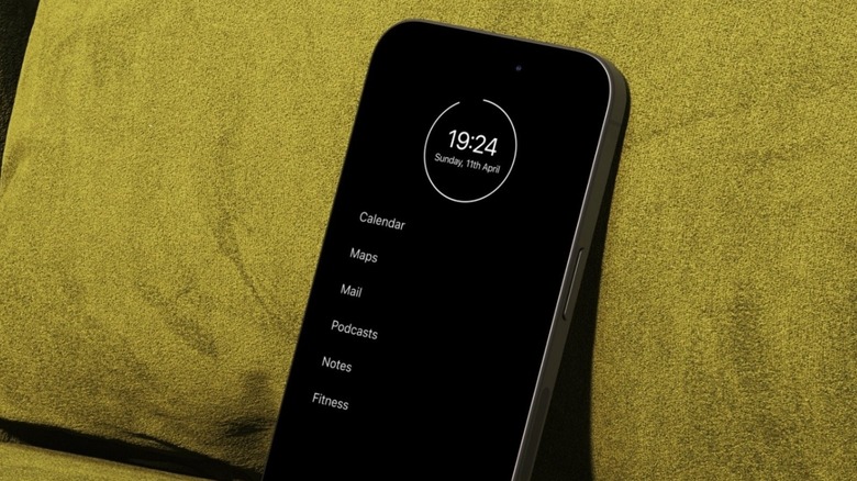 An iPhone running the Minimalist Phone app leaning against a cushion