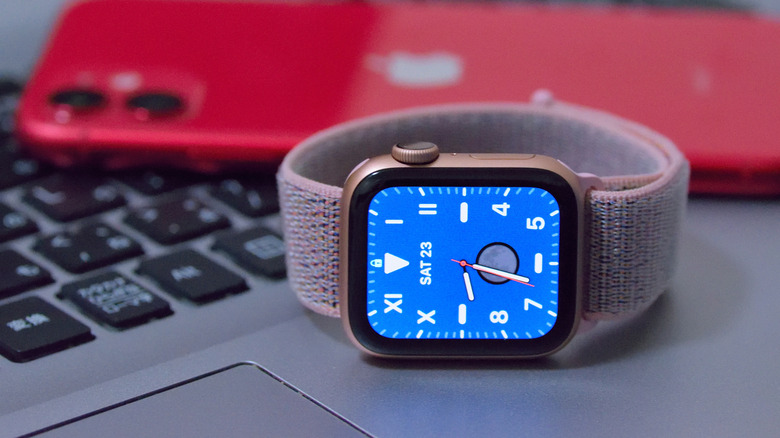 Apple Watch Series 5 on MacBook with iPhone behind it
