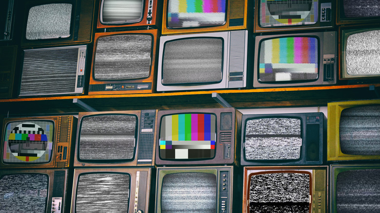 A graphical array of retro-style TVs displaying static and color test patterns.