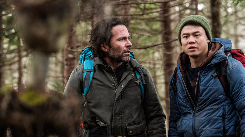 Eion Bailey and Ricky He as Jim Matthews and Kenny Liu looking at a figure in "From"