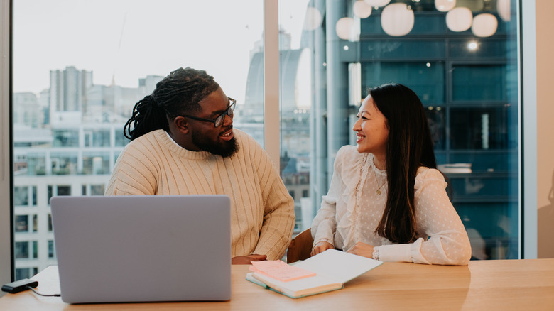 Two people working together.