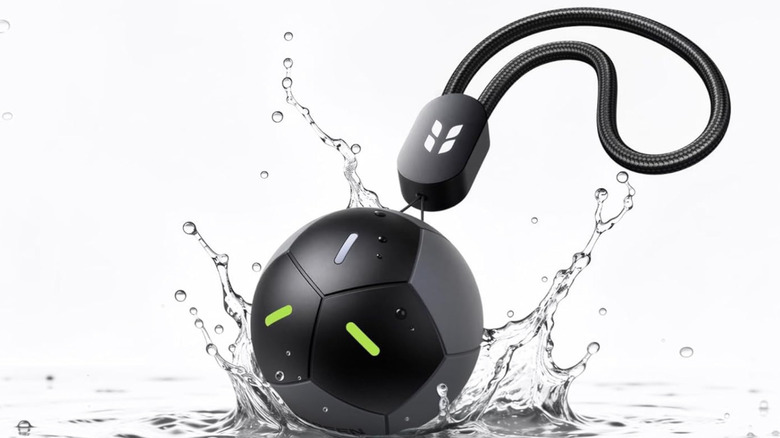 The UGREEN FineTrack 2 falling into a puddle.