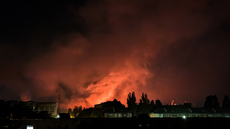 An explosion sends billows of red smoke over Kyiv following a Russian drone attack.