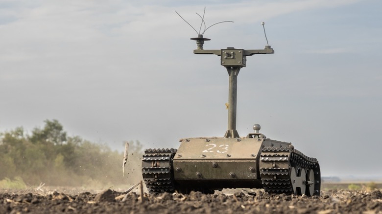 A Ukrainian unmanned ground vehicle treads across a dirt field.