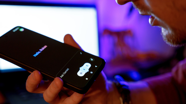 Man uses Google Gemini app on a smartphone