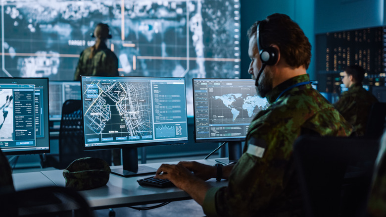 Military personnel in operations center utilizing AI to conduct warfare