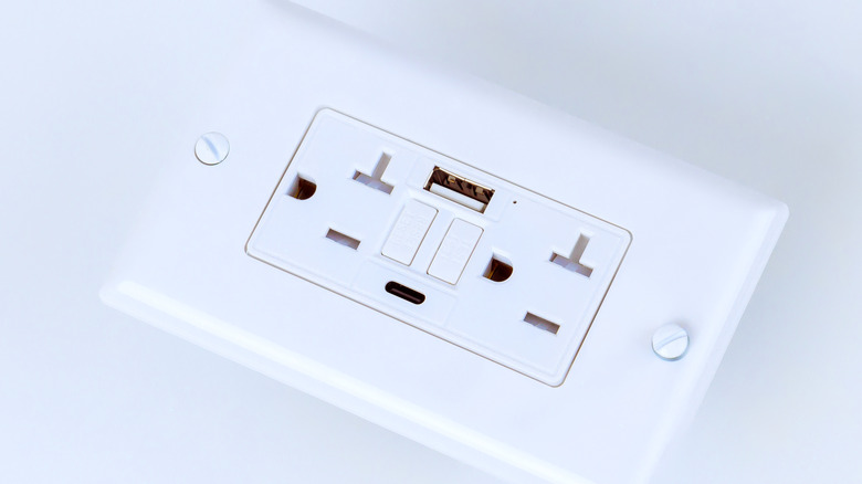 A USB port on a wall power outlet.