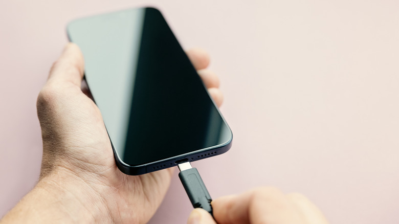 A USB Type-C being plugged into an iphone.