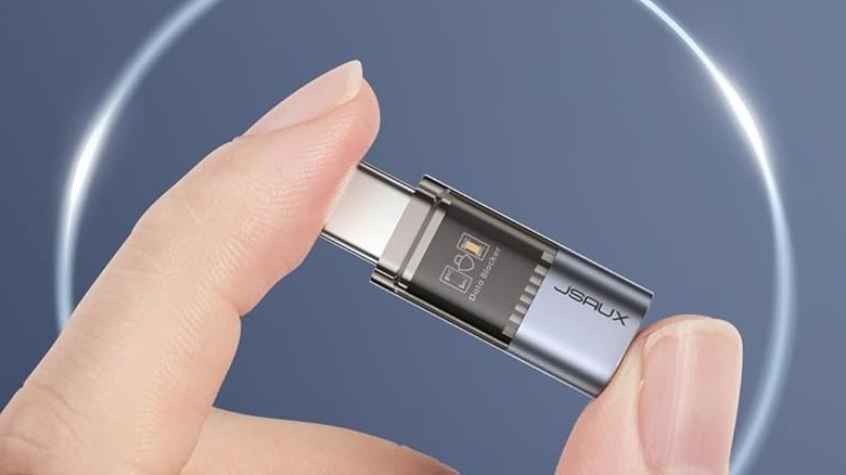 A person holding a JSAUX USB-C data blocker.