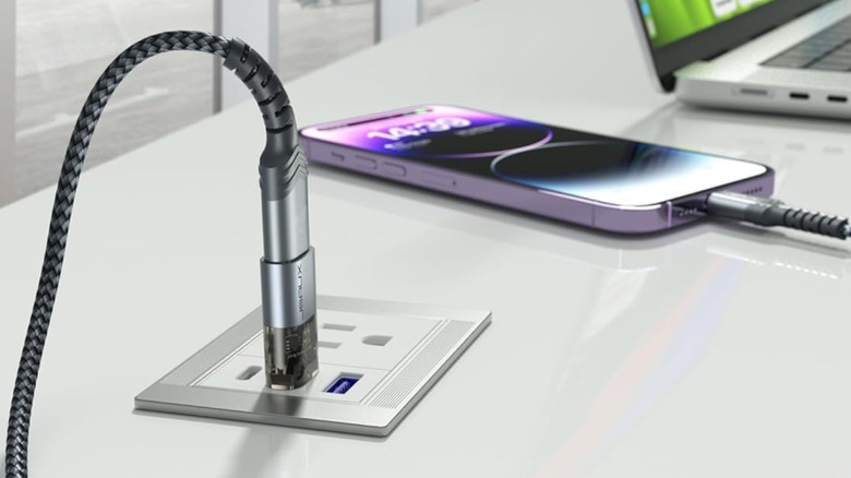 The JSAUX USB data blocker connected to a public USB port.