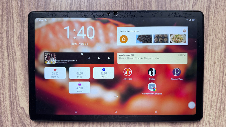 Old tablet showing home screen with different kitchen apps and widgets