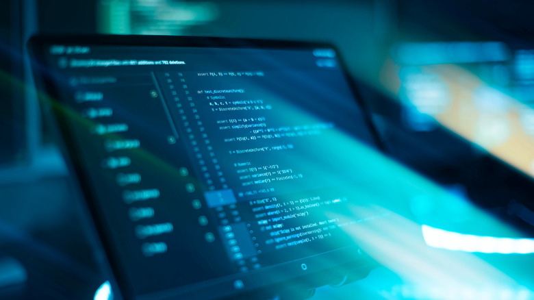 Monitor closeup of function source code with an abstract IT technology background