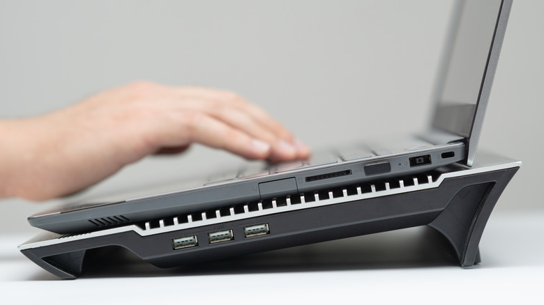 a laptop with a cooling pad underneath it