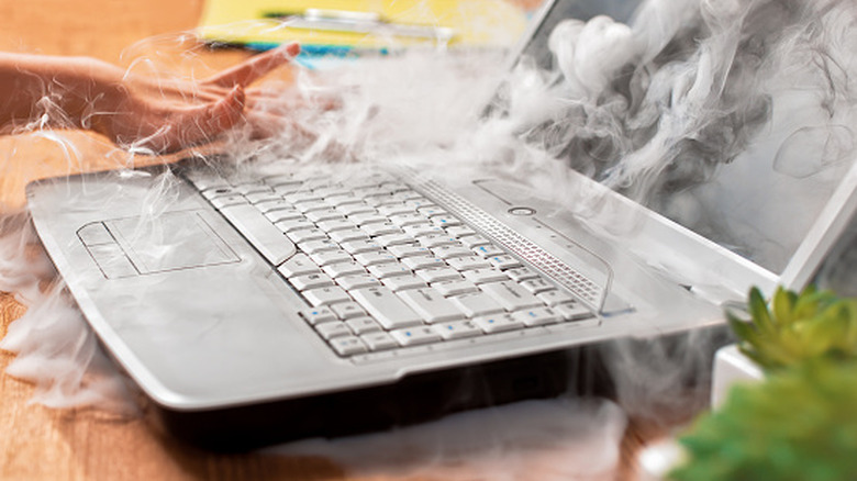 a smoking laptop from overheating