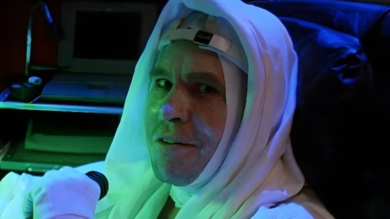 Montgomery (Val Kilmer) wearing a white head dress in "The Island of Dr. Moreau."