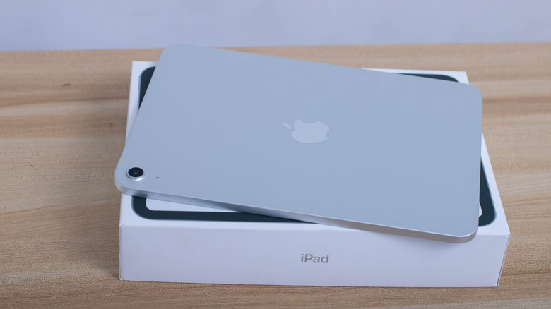 The iPad 11 face down, on top of its retail box.