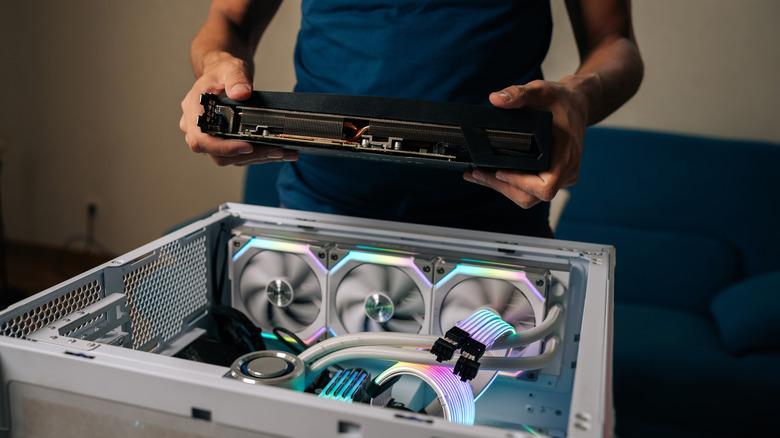 A technician deciding how to install a new GPU into a gaming PC