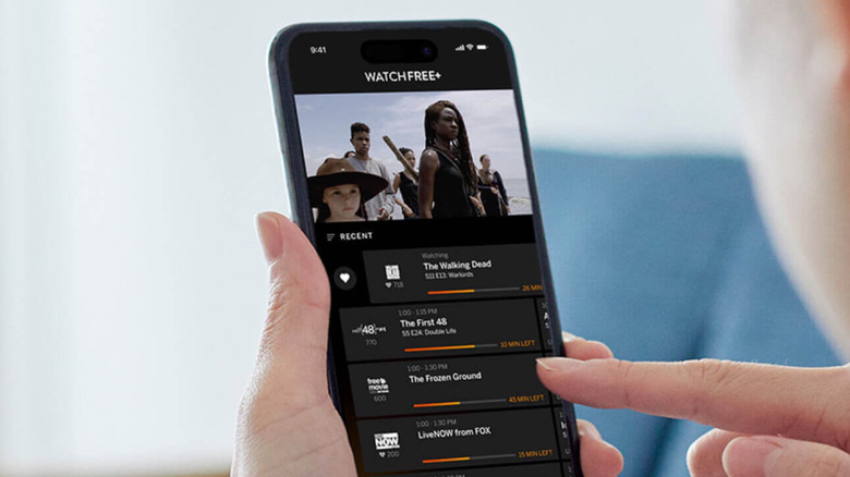 A person using a smartphone to access WatchFree+.