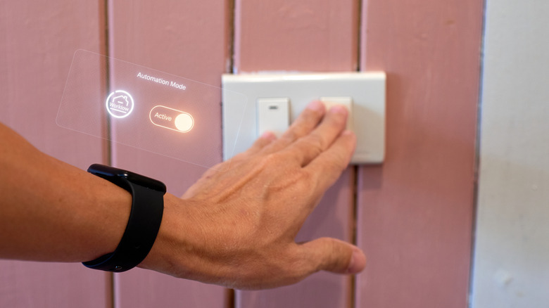 A person pressing a switch, with Automation Mode shown as active via an illustration