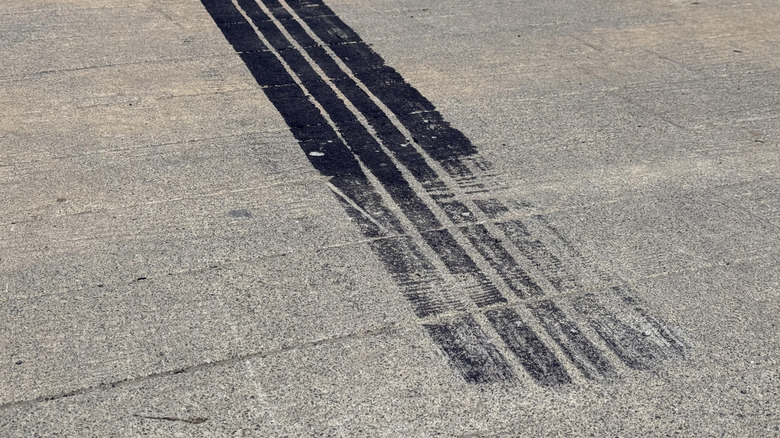 A tire skid mark on an asphalt road.