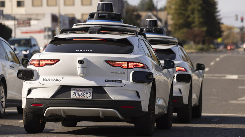 Waymo autonomous vehicle robotaxis stopped at red light