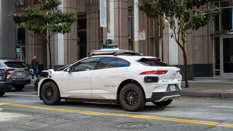 a Waymo self-driving taxi outside of a building