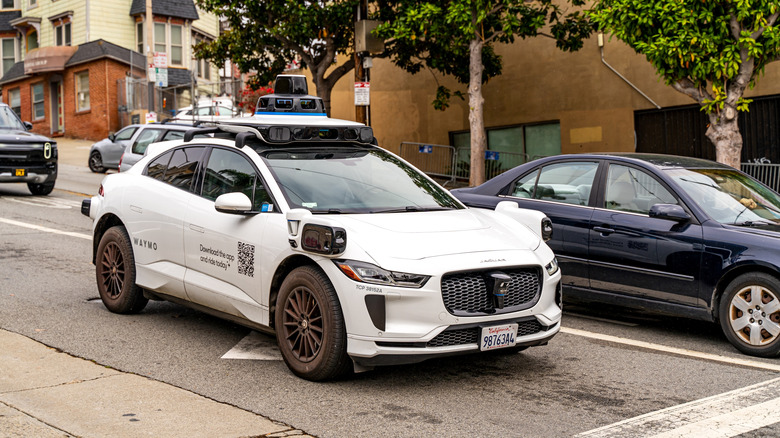 a waymo robotaxi stopped at an intersection in the city