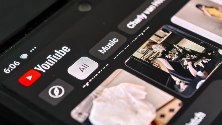 A smartphone displaying the YouTube mobile app home screen in dark mode