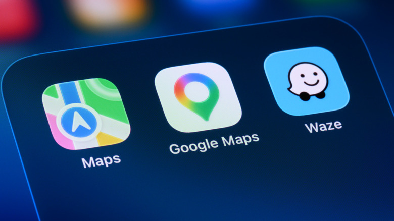 Apple Maps, Google Maps, and Waze app icons on an iPhone.
