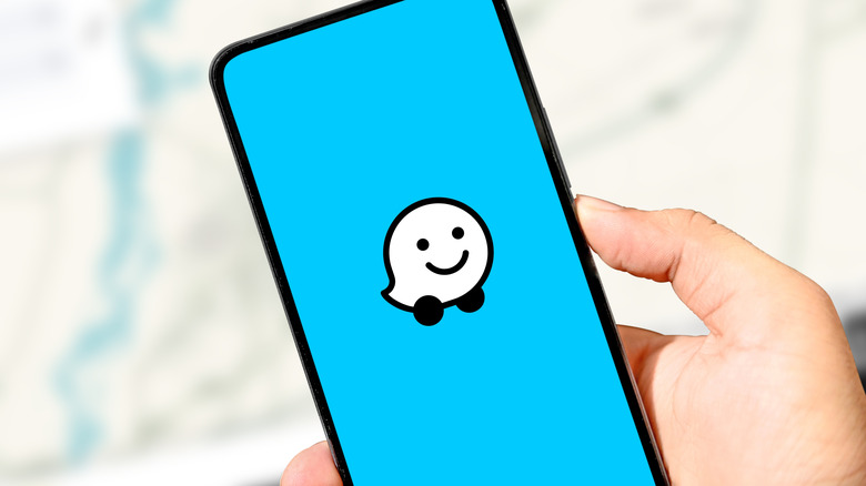 The Waze logo displayed on a smartphone.