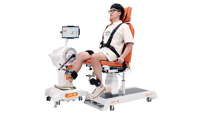 Person sitting in isokinetic training device