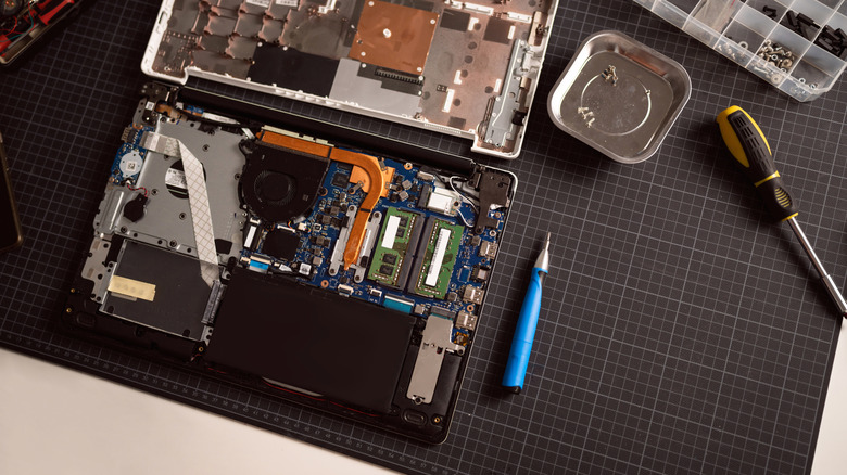 Overhead view of laptop taken apart with internal components visible.